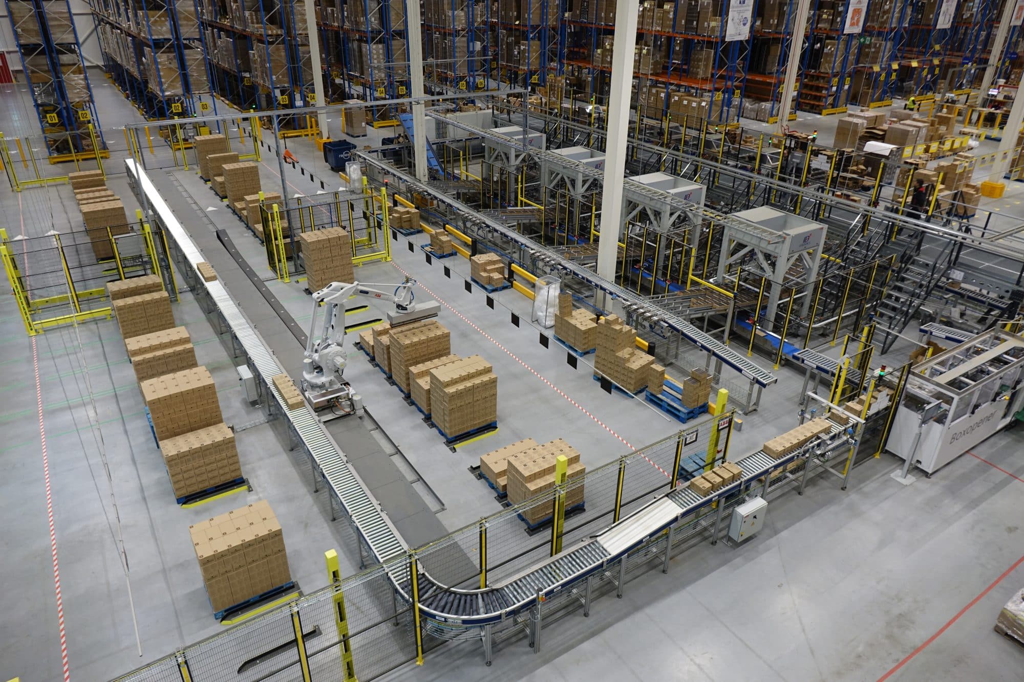 Vista general de un almacén/departamento de logística en una fábrica de Nespresso. Un sistema transportador -construido con componentes modulares de Easy Conveyors- recorre toda la zona.